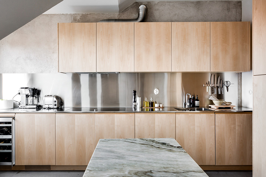 a kitchen of natural wood and steel