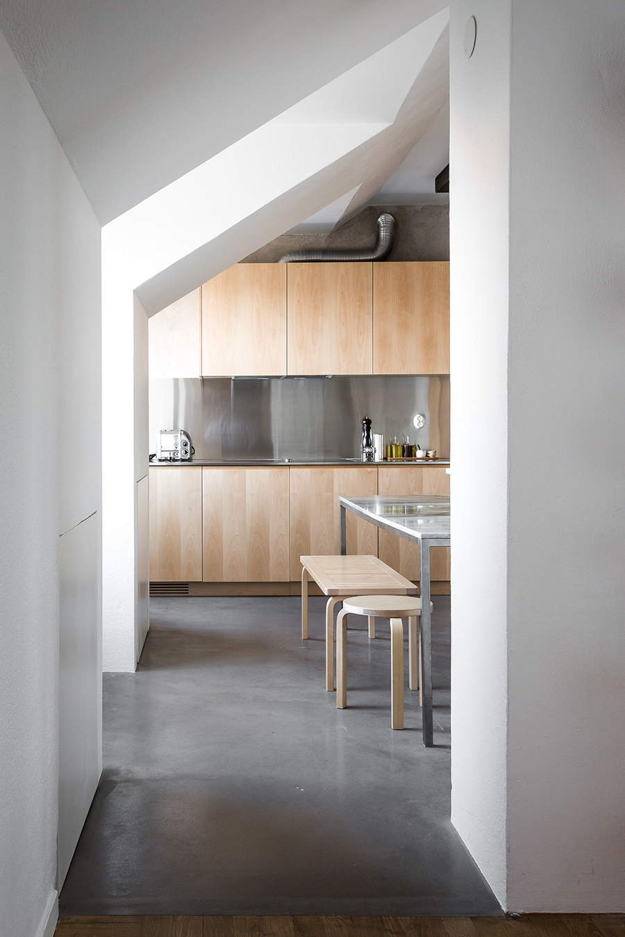 a kitchen of natural wood and steel